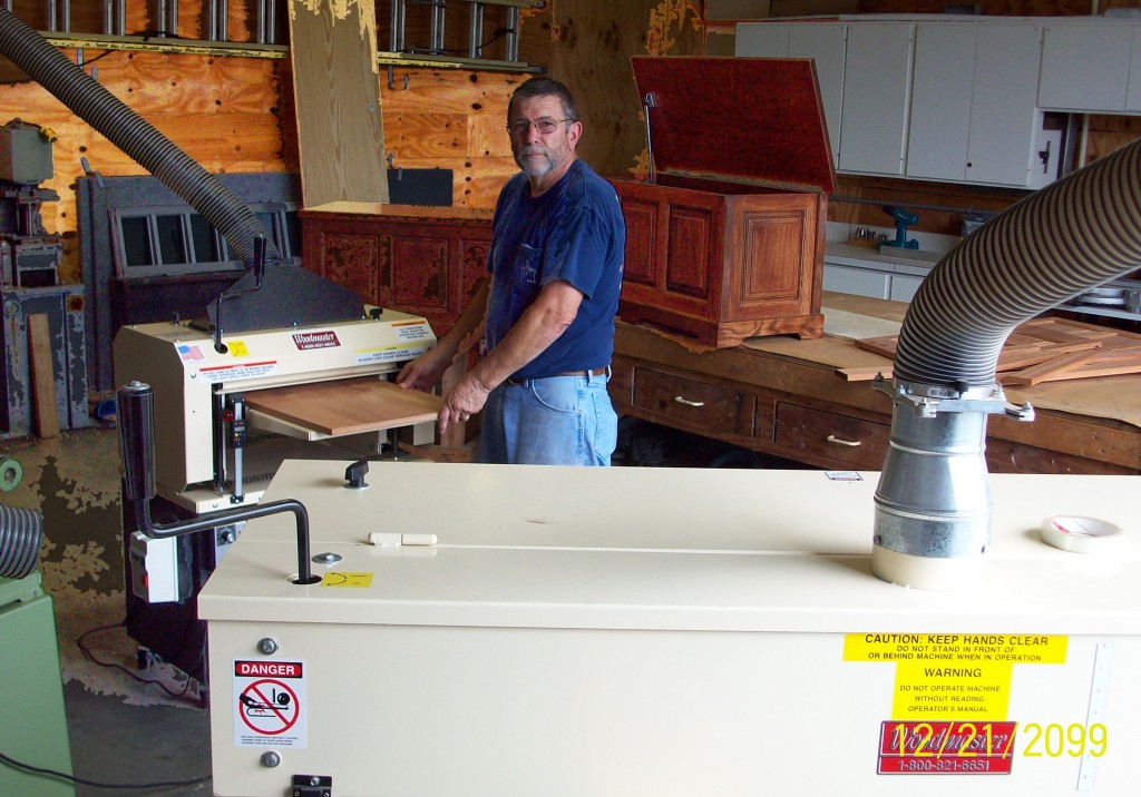 Here's Charles in his workshop, running a panel through his Woodmaster Molder/Planer while his Woodmaster Drum Sander stands ready (foreground). Behind Charles are two of the toy boxes he's made for his grandkids. He has his work cut out for him: when we spoke, he had 13 grandkids, "And one on the way!"