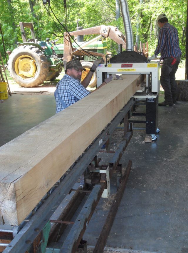 Tom (kneeling) and a friend surfaced 150 hardwood beams plus siding, paneling, and more.