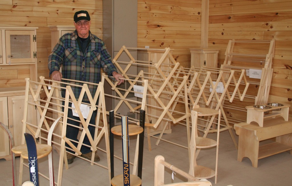 Glen Tompkins displays his wares in the showroom of his workshop. Glen's best-selling product is a line of folding clothes drying racks he manufactures for a chain of Maine department stores. He also builds a number of other product lines including picnic tables, Adirondack chairs, and items shown here..